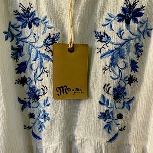 Lightweight top with an embroidered design featuring intricate floral patterns.